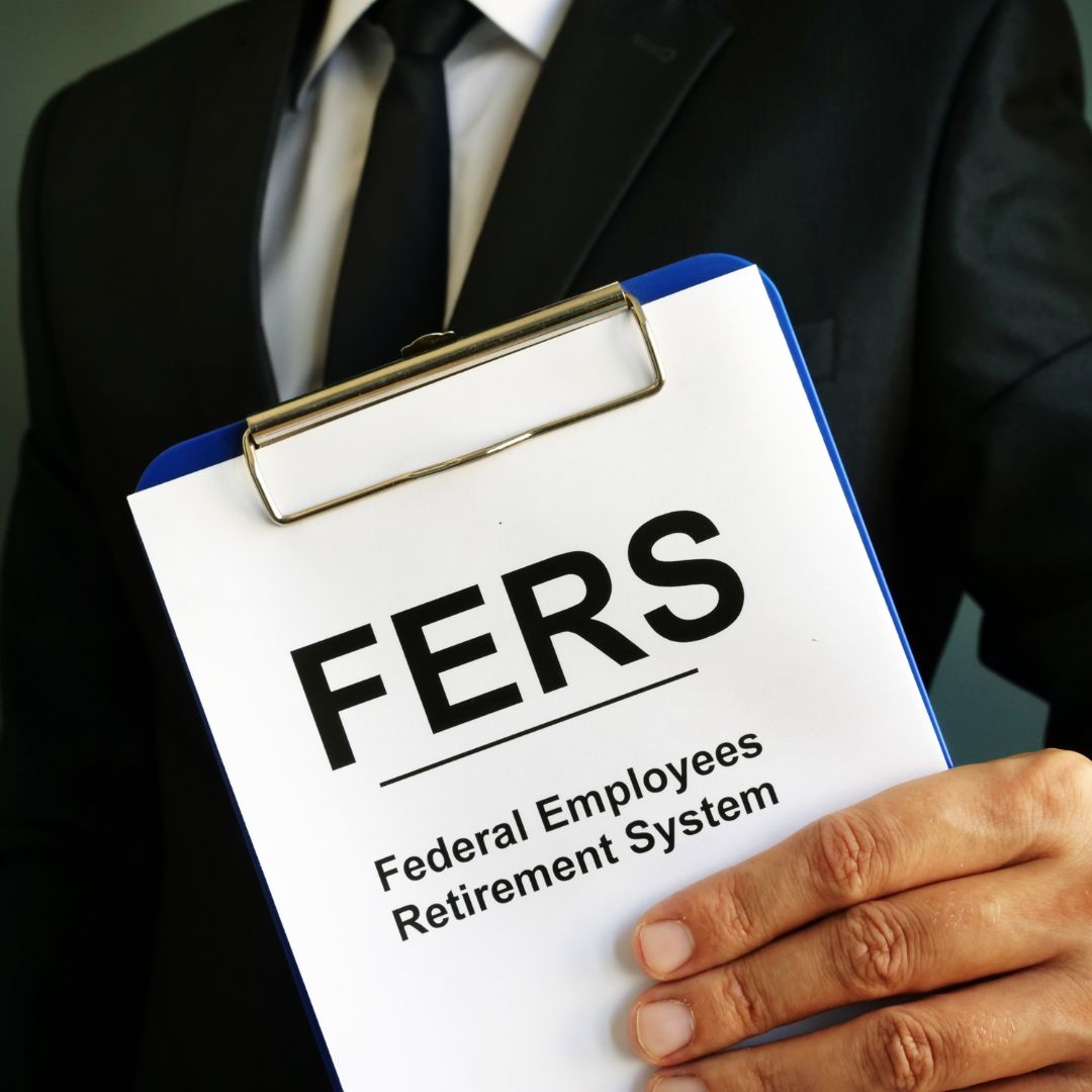 Man holding clipboard with "Federal Employee Retirement System" typed on the paper