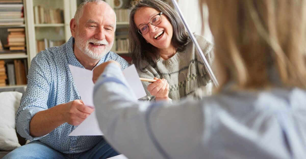 Mature couple speaking with an agent